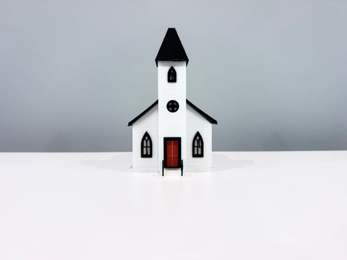 Front view of the Church miniature showing its spire, round window and red entrance door.