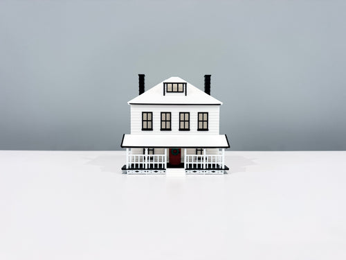 Front view of the Farmhouse miniature showing its windows, porch and two chimneys.