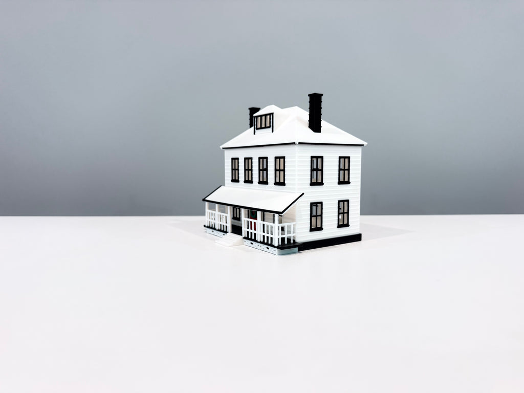 Opposite angled view of the Farmhouse miniature showing its side wall and wide porch.