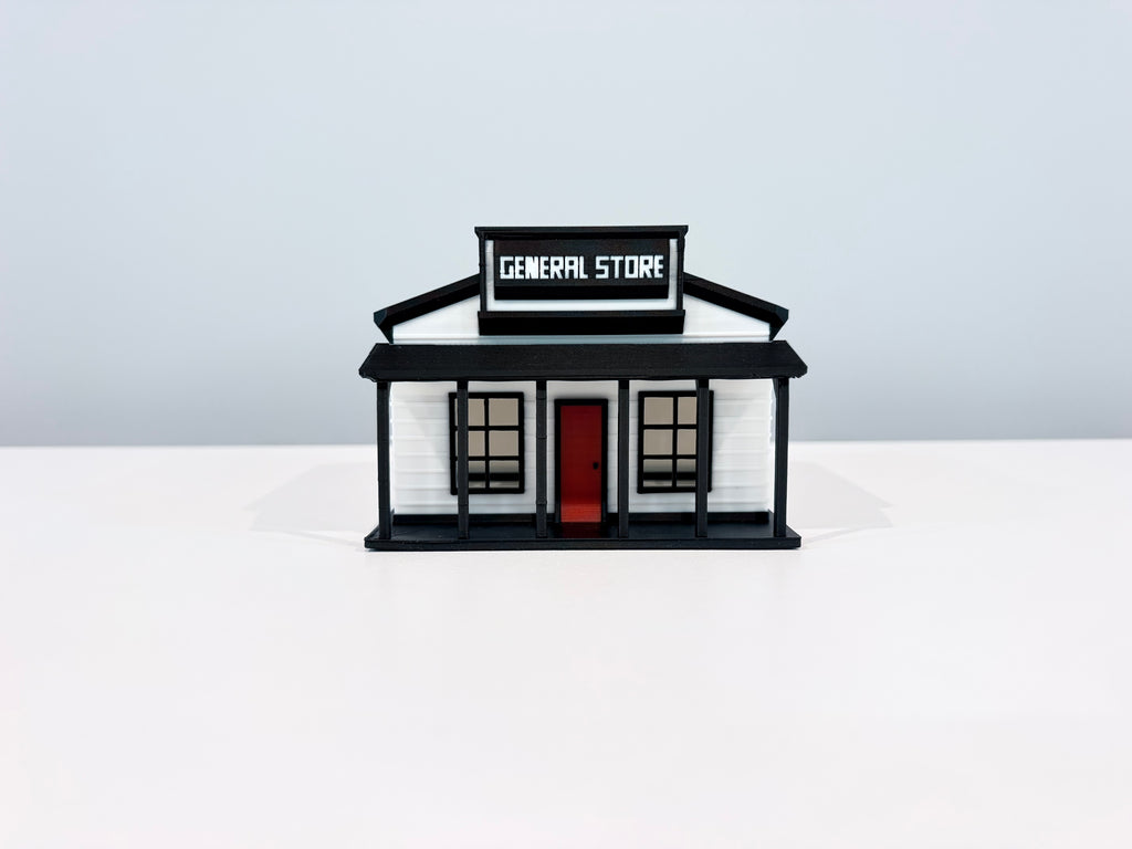 Front view of the General Store miniature showing its sign, porch posts and red door.