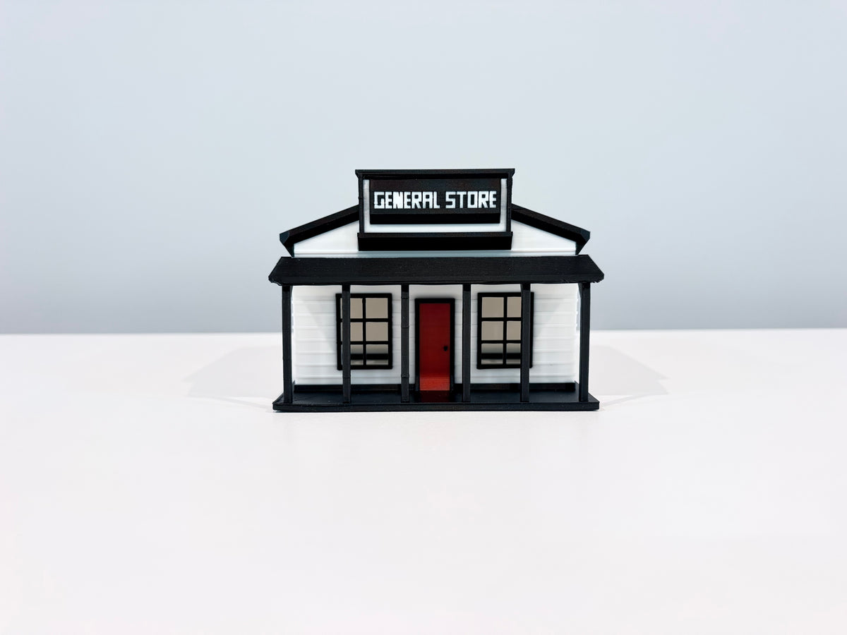 Front view of the General Store miniature showing its sign, porch posts and red door.