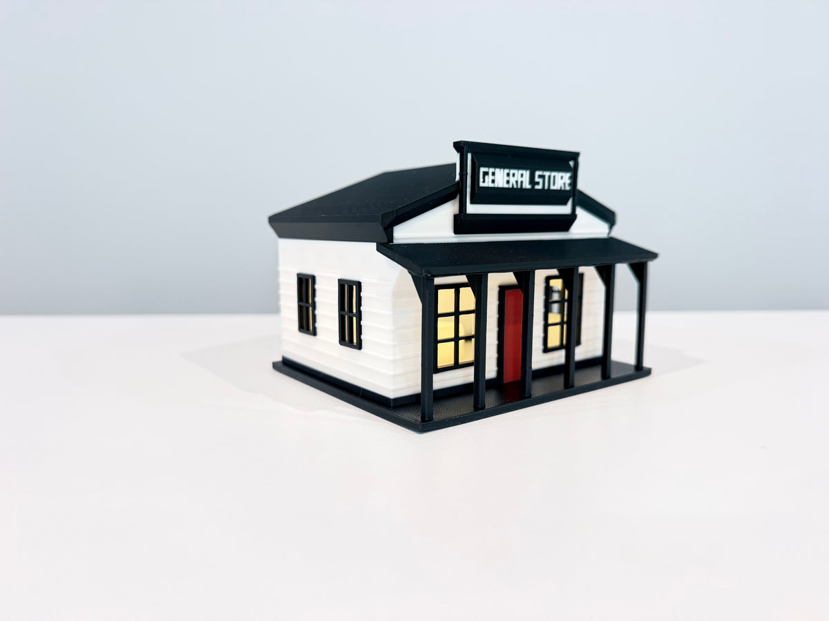 General Store miniature with warm light visible through its storefront windows.